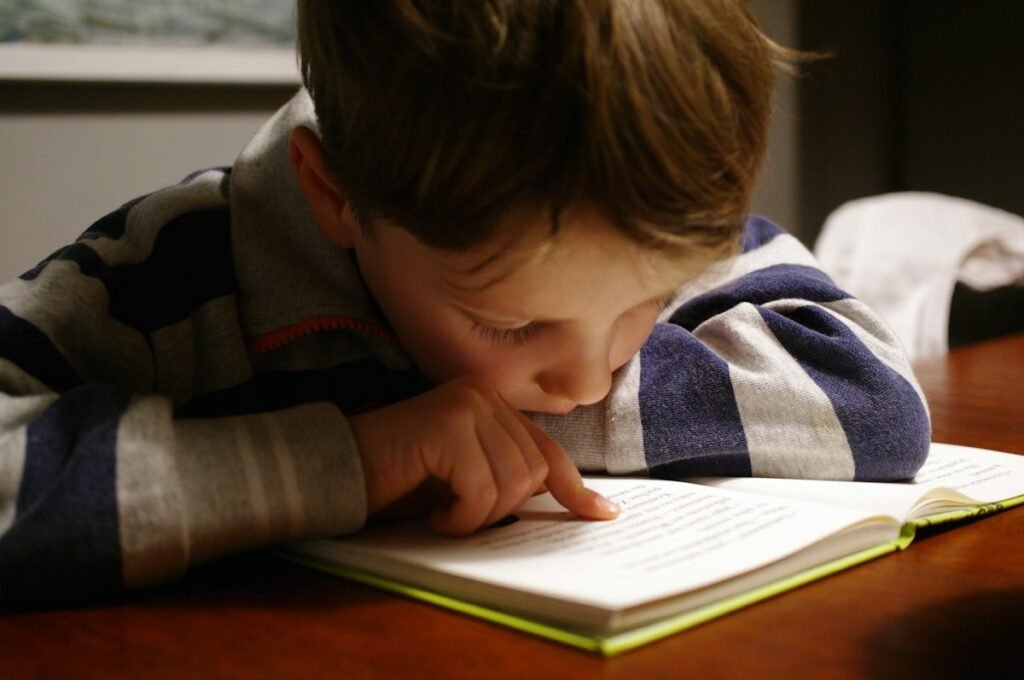 Child reading a book in warm natural light, exploring independently