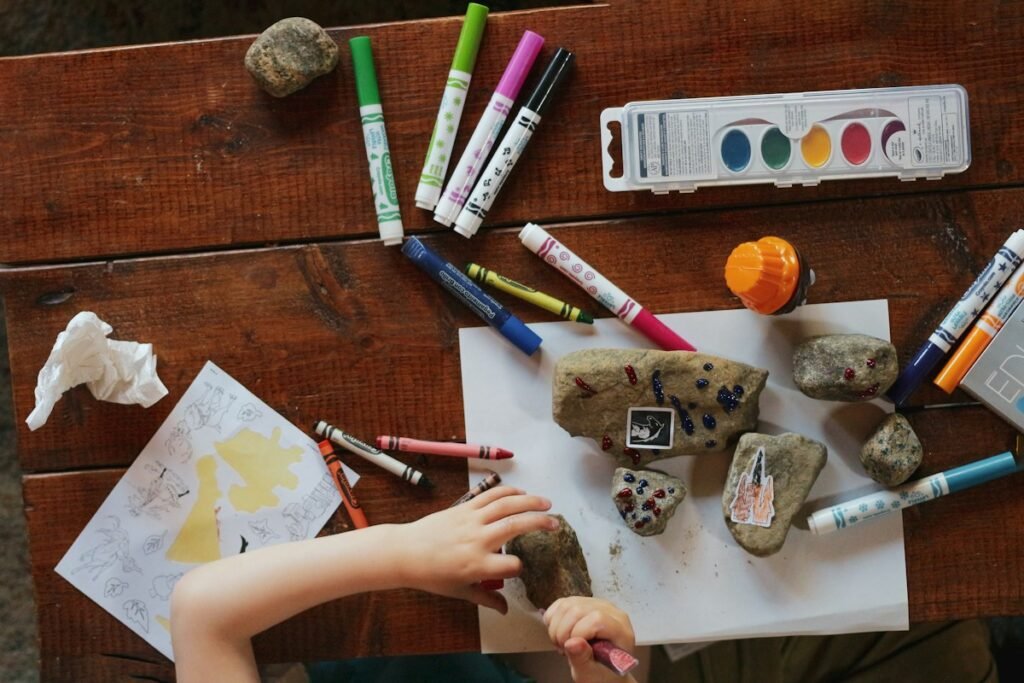 Children engaged in creative art and craft activity at a table